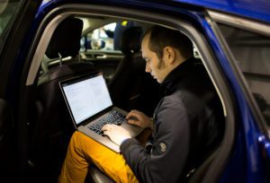 Student with computer in smart car