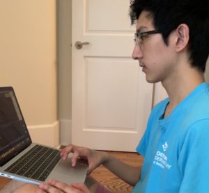 Jonathan Lin on his laptop