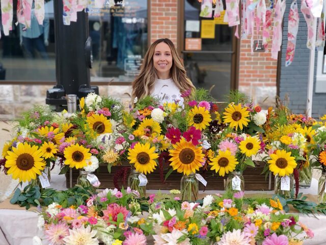 Mcity's Kasie Meszaros is pictured with her flowers at a local farmers' market.
