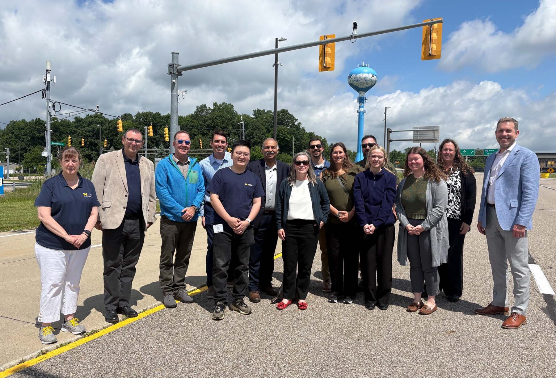 University of Michigan and Federal Highway Administration leadership stand together at the Mcity Test Facility