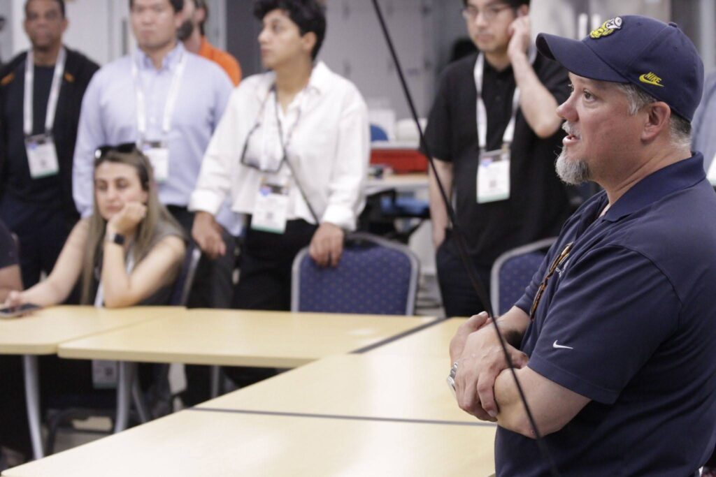 Jim Lollar in the Mcity Auxiliary building with ASCE attendees in the background