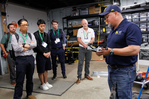Jim Lollar holds a drone swarm in front of attendees at the ITSA Conference