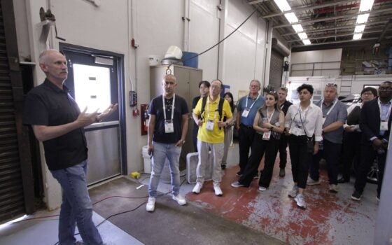Mark Gilbert stands in a high bay with attendees from the ASCE conference