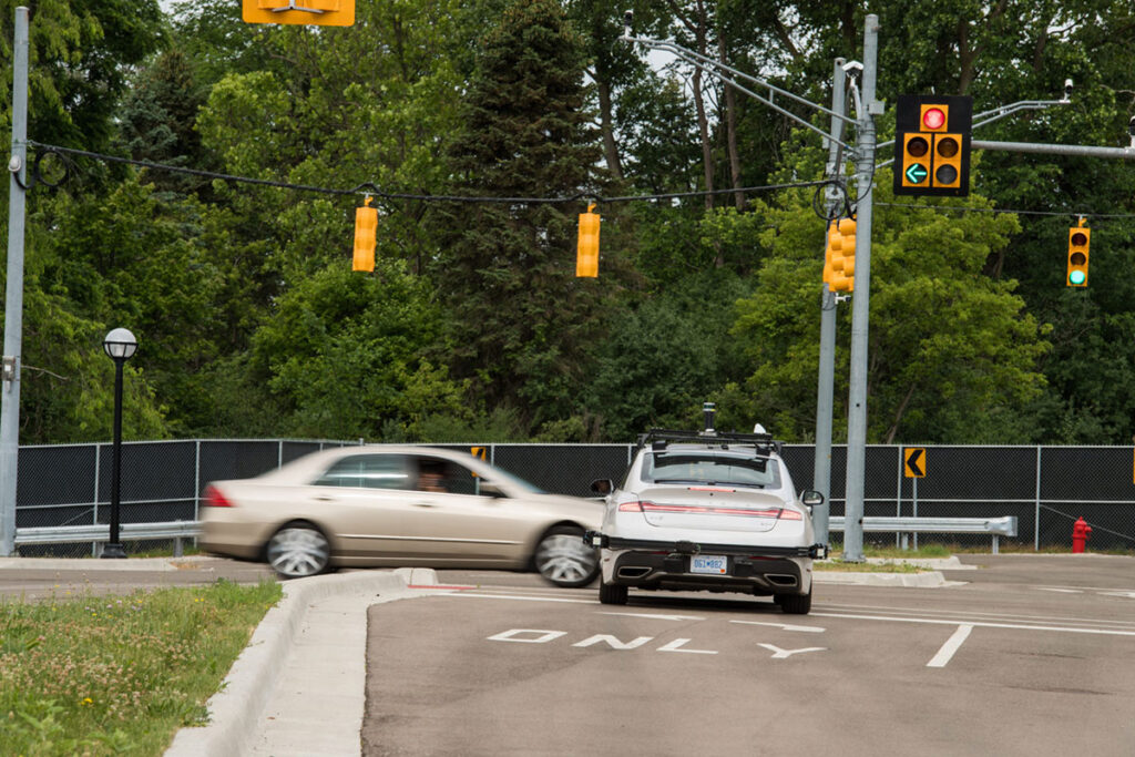 An Mcity driverless Lincoln MKZ research vehicle avoids a collision during a 2017 demo of connected and automated vehicle (CAV) technologies.